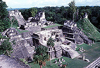 Large stone buildings on top of a grassy hill