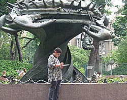 Jason stands in front of a statue that looks like a crab