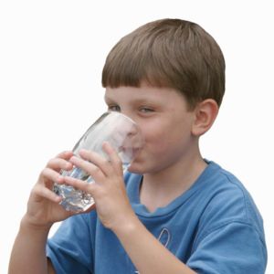 Picture of a boy drinking from a water glass. 