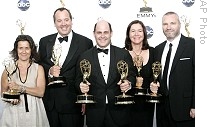 Executive Producer Matthew Weiner, center, holds award for outstanding drama series as he is joined by members of producing team for