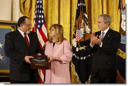 President George W. Bush leads the applause in honor of Petty Officer Michael A. Monsoor after presenting the Congressional Medal of Honor posthumously to his parents, George and Sally Monsoor, during ceremonies Tuesday, April 8, 2008, at the White House. The 25-year-old Navy SEAL was killed in Iraq in 2006 after he threw himself on a grenade to save his fellow SEALS when they came under attack while on duty in Ramadi. White House photo by Eric Draper