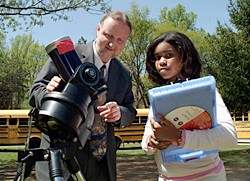 Lou Mayo and a student use a telescope to study the sun
