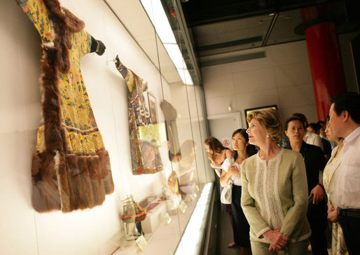 Mrs. Laura Bush closely examines a display at the Exhibition of Imperial Garments and Jewelry Saturday, Aug. 9, 2008, during her tour of the Forbidden City in Beijing. White House photo by Shealah Craighead