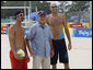 President George W. Bush pauses with U.S. Men's Beach Volleyball's Todd Rogers, left, and Philip Dalhausser as he visited the practice session Saturday, Aug. 9, 2008, at Beijing's Chaoyang Park prior to their first matches of the 2008 Summer Olympic Games. White House photo by Eric Draper