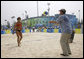 President George W. Bush hits a volleyball back to U.S. Women's Beach Volleyball team member Misty May-Treanor, left, during his visit to the Chaoyang Park practice courts Saturday, Aug. 9, 2008, before the U.S. team began their matches at the 2008 Summer Olympics in Beijing. White House photo by Eric Draper