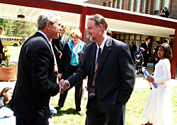 Lou Mayo and President Bush shake hands outside a school