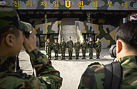 Republic of Korea Army photographers photograph Chairman of the Joint Chiefs of Staff U.S. Navy Adm. Michael G. Mullen and his tour guides in front of Observation Post Dora, Demilitarized Zone, Republic of Korea, Nov. 5, 2007. Defense Dept. phot by U.S. Navy Petty Officer 1st Class Chad McNeeley