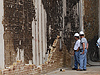 Workers examine damage to a flame trench wall.