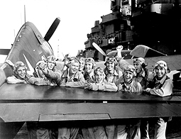 Photo of US Pilots on the Deck of a US Carrier Cheering Beside Their Plane 