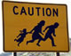 Official CALTRANS sign warning California motorists to watch out for illegal immigrant crosser