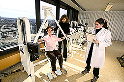 Jennifer Layne and Charlotte Mallio test a volunteer's muscle strength. Link to photo information