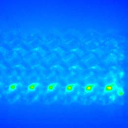 E.coli bacteria adhere to six posts of a microfluidic biochip; light blue, green, and yellow colors in a consecutive circles pattern show increasing densities near the center of each post