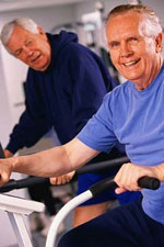 Older men on exercise bikes