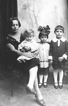 Prewar photograph of three Jewish children with their babysitter. Two of the children perished in 1942. Warsaw, Poland, 1925-1926.