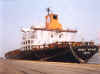 A cargo vessel moored to a pier.