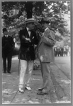Sen. Claude A. Swanson and Ray Baker standing on sidewalk and talking, LC-USZ62-89803 (Harris & Ewing photograph print)
