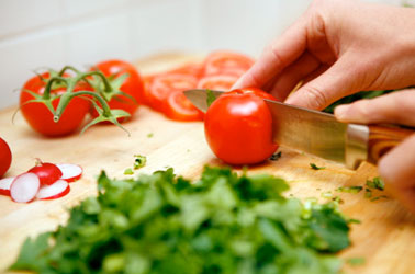 Knife cutting fresh vegetables