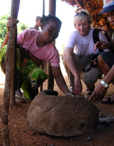 Photo of a local villager showing Judy Oglethorpe of WWF-US how the fuel-saving stoves are constructed.