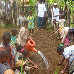 Photo of a group of children planting a garden. Source: Conservation International.