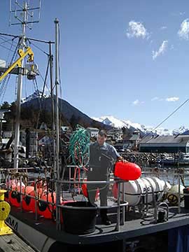 NMFS Enforcement Officer Wynn Carney inspecting seabird avoidance gear in Sitka