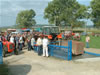 Visitors at the livestock fair in the Town of Pleternica watch the first tractor cross over to the newly built disinfection barrier