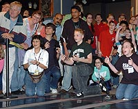 Students and spectators cheer fuel-cell-powered model cars while contest official watch during the 2006 Fuel Cell sprint