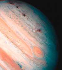 Scars from the crash of Comet Shoemaker-Levy 9 appear on Jupiter's surface as a series of maroon blotches in this photo. The comet broke into 21 pieces before it hit Jupiter in 1994.