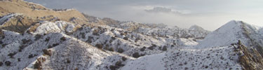 Snow on tilted rock layers.