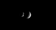 This animation show two crescent moons dance around Saturn as far-off Dione slips behind its 
sibling moon Rhea