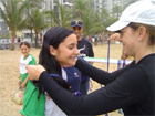 Ashley Dean gives an excited Brazilian participant her medal.