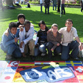 Photo of ECA programs alumni creating a multi-nation flag poster