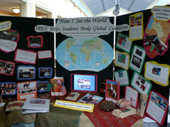 Photo of students displaying pictures, quotes, and questions from the forum entitled “How I See the World”