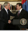 President George W. Bush shakes hands with President Nambaryn Enkhbayar of Mongolia, Monday, Oct. 22, 2007, in the Roosevelt Room of the White House, where the two leaders signed the Millennium Challenge Corporation Compact.
