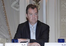 NTIA Assistant Secretary John M.R. Kneuer seated at table.