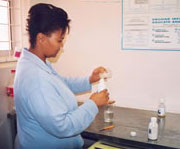 Photo of a pharmacist filling a prescription at a local clinic in South Africa.