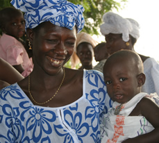 Photo of a woman holding a baby. Source: USAID/Senegal