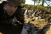 A midshipman makes his way through a simulated fox hole at the "Wet and Sandy" obstacle course located at Hospital Point at the U.S. Naval Academy, Annapolis, Md., May 13, 2008. 