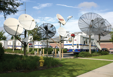 Surrounded by a bristling forest of communications devices, Florida mobile command vehicles stand by to deploy for a hurricane emergency.