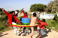 Photo of children playing by the PlayPumps water system.