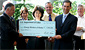 Secretary Chao (front row, center) presents a grant to Alaska Lt. Gov. Loren Leman (front, right) and Alaska Labor Commissioner Greg O'Claray (front, left), as Bob Morigeau of the Operating Engineers Local 302 (back row, left to right), Gloria O'Neil of the Cook Inlet Tribal Council, Paul Fuhs of the Marine Exchange of Alaska, and David Mathews of the H.C. Price Company look on.