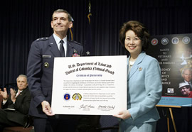 Secretary of Labor Elaine L. Chao (right) and Maj. Gen. David Wherley (center), Commanding General of the District of Columbia National Guard celebrate the adoption of the D.C. National Guard by the U.S. Department of Labor on Friday, November 14, as Secretary of Veterans Affairs Anthony J. Principi (left) looks on. (DOL Photo/Shawn Moore) 