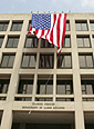 Image of American flag flying from the U.S. Department of Labor building.