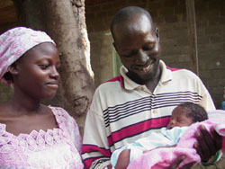 Photo of proud parents smiling upon their newborn daughter Atikta Haoua Riane.