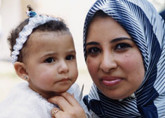 Photo of a woman and her infant attending a one-day event promoting family planning and reproductive health among youth in Port Said, Egypt.