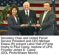Secretary Chao and United Parcel Service President and CEO Michael Eskew (R) present Labor Hall of Fame trophy to Paul Casey, nephew of UPS Founder James E. Casey. (DOL Photo/Shawn Moore)