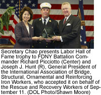 Secretary Chao presents Labor Hall of Fame trophy to FDNY Battalion Commander Richard Picciotto (Center) and Joseph J. Hunt (R). (DOL Photo/Shawn Moore)