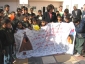 Secretary Chao presents	a banner created by Indian Hills Elementary School students in Hopkinsville, Kentucky to the Iraqi children at the Al Waziriya Orphanage.