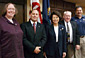 Secretary  Chao (center) and Wage & Hour Administrator Tammy McCutchen (far left), Fraternal Order of Police officials Chuck Canterbury (second from left); Martin Scott (second from right); and Mike Hettich (far right).