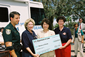 Secretary Chao (second from right) presents a $50 million National Emergency Grant to help Floridians recover from Hurricane Charley and Tropical Storm Bonnie to Florida Lieutenant Governor Toni Jennings (far right) and Susan Pareigis, Director of the Governor's Agency for Workforce Innovations (second from left), as Jim Troiano, Public Information Officer for the Arcadia, Fla., Emergency Operations Center looks on.