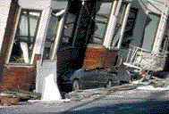 Loma Prieta Earthquake: An automobile lies crushed under the third story of this apartment building in the Marina District.